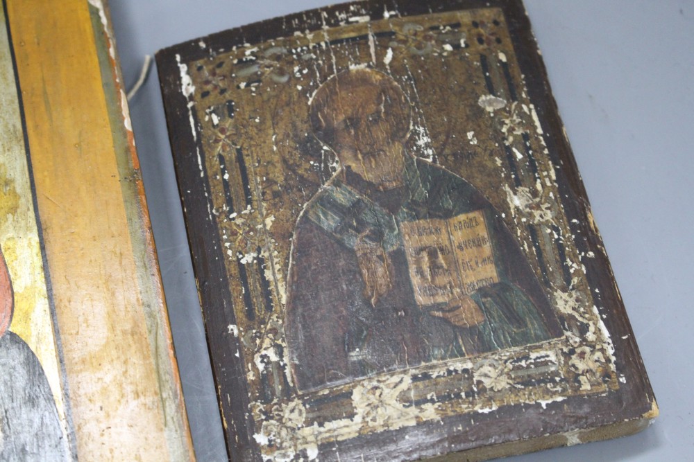 A 19th century Russian tempera on wood icon, 31 x 26cm and another smaller icon, 17.5 x 13cm